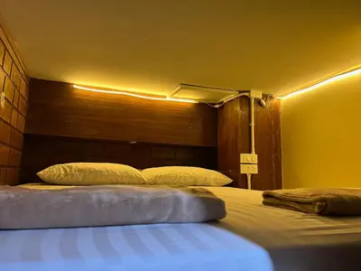 a bedroom with two beds in a room at LONGDOO Hostel in Phi Phi Don