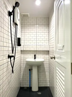 a white bathroom with a sink and a window at LONGDOO Hostel in Phi Phi Don