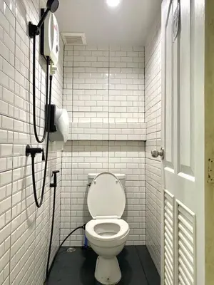 a bathroom with a white toilet in a stall at LONGDOO Hostel in Phi Phi Don