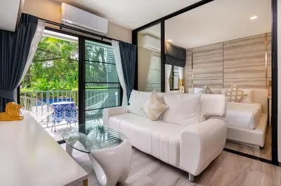 a living room with a white couch and a glass table at F12 Номер Люкс Бассейн Рубль ВАТСАП669З582I976 in Nai Yang Beach