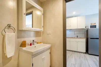 a small kitchen with a sink and a refrigerator at F12 Номер Люкс Бассейн Рубль ВАТСАП669З582I976 in Nai Yang Beach