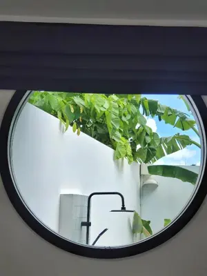 a window in a room with a plant at Villa Coco - Tropical Paradise with Private Pool in Thalang