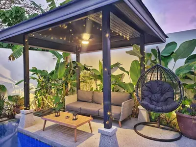 a gazebo with a couch and a swing at Villa Coco - Tropical Paradise with Private Pool in Thalang
