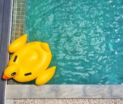 a yellow rubber duck sitting next to a swimming pool at Villa Coco - Tropical Paradise with Private Pool in Thalang