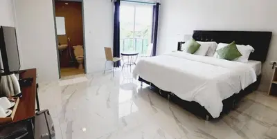 a bedroom with a large bed and a bathroom at PR ROOM FOR RENT in Kamala Beach