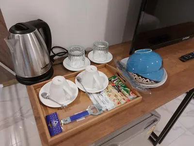 a wooden counter top with dishes and a tea pot at PR ROOM FOR RENT in Kamala Beach