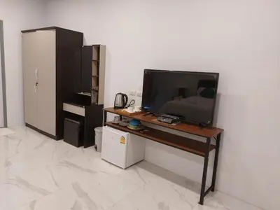a television sitting on a desk in a room at PR ROOM FOR RENT in Kamala Beach