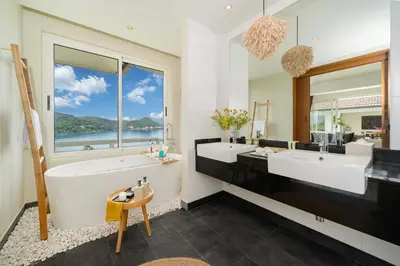 a bathroom with two sinks and a large window at Stunning 5 bedrooms Villa with Panoramic Sea View in Por Bay