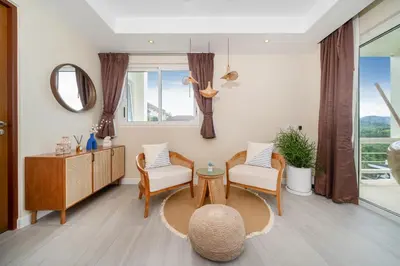 a living room with chairs and a table and a mirror at Stunning 5 bedrooms Villa with Panoramic Sea View in Por Bay