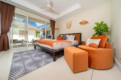 a bedroom with a bed and a couch and a chair at Stunning 5 bedrooms Villa with Panoramic Sea View in Por Bay