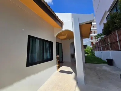 a house with a large window on the side of it at PoolVilla 234 Patong in Patong Beach
