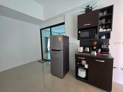 a kitchen with a stainless steel refrigerator and a counter at PoolVilla 234 Patong in Patong Beach