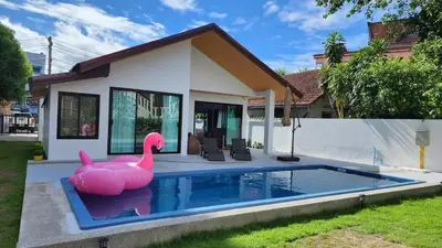 a pink inflatable pink flamingo in front of a house at PoolVilla 234 Patong in Patong Beach