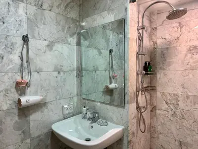 a bathroom with a sink and a shower at 1bdr Pool Access Apartment Rawai Beach Condominium by Capital Pro in Phuket Town