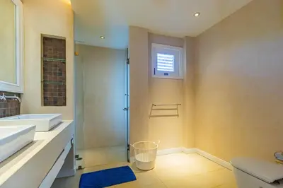 a bathroom with a shower and a sink and a toilet at 3BR Casa Azul - Beachfront Home in Laguna & Layan Chom Tawan and Maan Tawan Residences in Phuket Town
