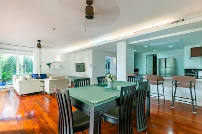 a dining room and living room with a table and chairs at 3BR Casa Azul - Beachfront Home in Laguna & Layan Chom Tawan and Maan Tawan Residences in Phuket Town