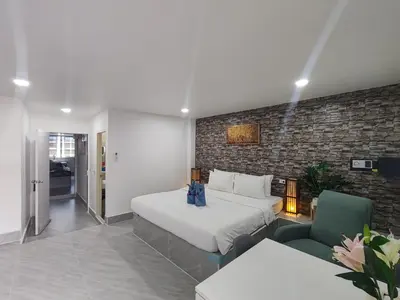 a hotel room with a large bed and a couch at My Home in Patong Beach