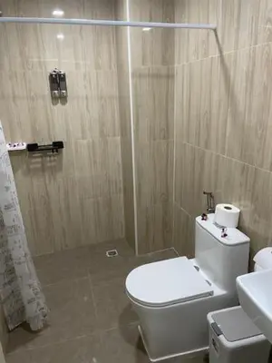 a bathroom with a white toilet and a shower at My Home in Patong Beach