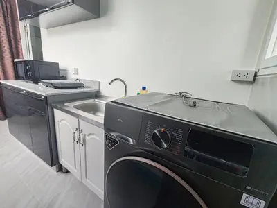 a kitchen with a sink and a washing machine at My Home in Patong Beach