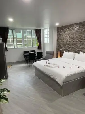 a bedroom with a large bed with flowers on it at My Home in Patong Beach