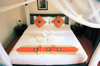 a bedroom with a bed with a box on it at Harmony Patong Hotel in Patong Beach