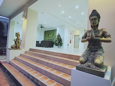 a statue sitting on the stairs of a building at Harmony Patong Hotel in Patong Beach
