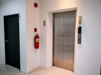 a fire hydrant on the wall next to a door at Harmony Patong Hotel in Patong Beach