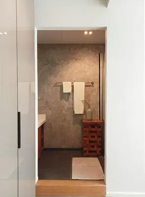 a bathroom with a shower with towels on a wall at Waterfront Suites Phuket by Centara NEW in Phuket Town