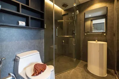 a bathroom with a toilet and a glass shower at Modern Condo in Boutique Style Resort CGB4 in Phuket Town