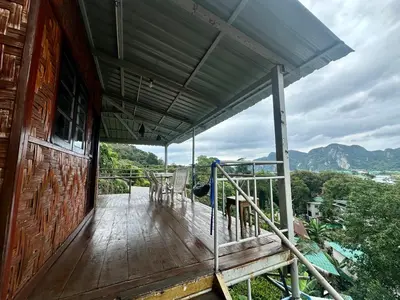 a balcony of a house with a view of the mountains at Hilltop view - Phi Phi in Phi Phi Don