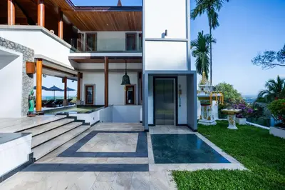 a house with a view of the yard at Villa ZeniMo in Phuket Town