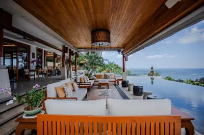 an outdoor living room with a view of the ocean at Villa ZeniMo in Phuket Town