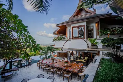 an outdoor dining area with a table and chairs at Villa ZeniMo in Phuket Town