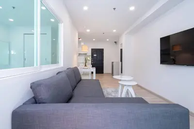 a living room with a couch and a table at Brand New Patong Apartment 1-Bedroom in Patong Beach