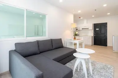 a living room with a couch and a table at Brand New Patong Apartment 1-Bedroom in Patong Beach