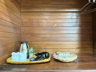 a tray with a coffee pot and a basket on a shelf at บ้านสวนปิยนันท์ (Baansuan Piyanan) in Ko Yao Noi