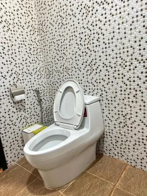 a bathroom with a toilet with the seat up at บ้านสวนปิยนันท์ (Baansuan Piyanan) in Ko Yao Noi