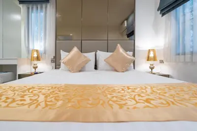 a bedroom with a large bed with two lamps at F11 Title 50м2 Люкс Бассейн Рубль ВАТСАП669З582I976 in Nai Yang Beach
