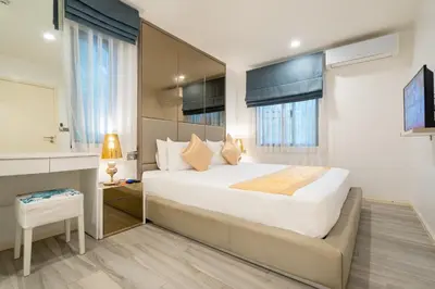 a bedroom with a large white bed and windows at F11 Title 50м2 Люкс Бассейн Рубль ВАТСАП669З582I976 in Nai Yang Beach