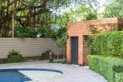 a brick wall with a door next to a pool at F11 Title 50м2 Люкс Бассейн Рубль ВАТСАП669З582I976 in Nai Yang Beach