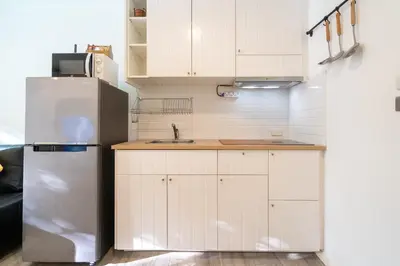 a kitchen with white cabinets and a refrigerator at F11 Title 50м2 Люкс Бассейн Рубль ВАТСАП669З582I976 in Nai Yang Beach