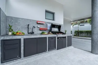 a kitchen with a sink and a stove at Two Flamingo Villa 1 in Ban Pak Lak