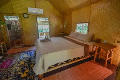 a bedroom with a large bed in a room at Ratanaporn Green in Phuket Town