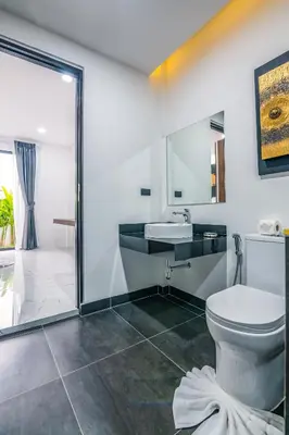 a bathroom with a toilet and a sink at Mango Hill Residence in Rawai Beach