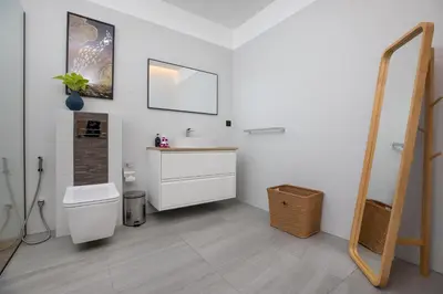 a bathroom with a toilet and a sink and a mirror at Mango Hill Residence in Rawai Beach