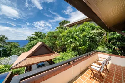 a balcony with a bench and a view of the ocean at Seaview 5BR Pool Villa Apsara, Free Breakfast and Full Service, 5 min walk to Kata Beach in Kata Beach