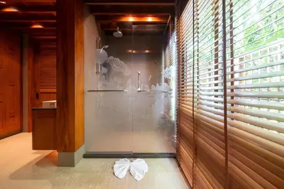 a bathroom with a shower with a glass door at Seaview 5BR Pool Villa Apsara, Free Breakfast and Full Service, 5 min walk to Kata Beach in Kata Beach