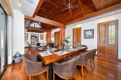 a dining room with a large wooden table and chairs at Seaview 5BR Pool Villa Apsara, Free Breakfast and Full Service, 5 min walk to Kata Beach in Kata Beach