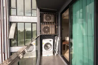 a washer and dryer sitting inside of a building at Aristo 1 Apartments by Beringela in Surin Beach