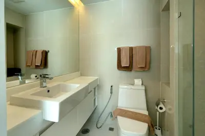 a white bathroom with a sink and a toilet at Aristo 1 Apartments by Beringela in Surin Beach